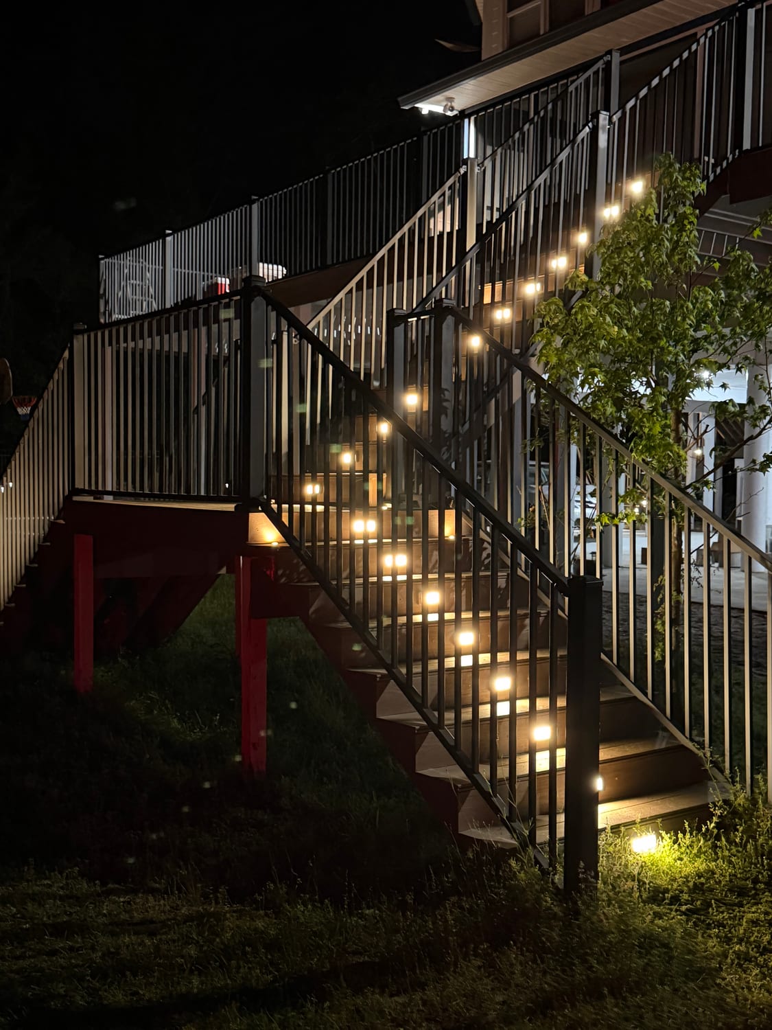 Warm LED step lights on a deck staircase