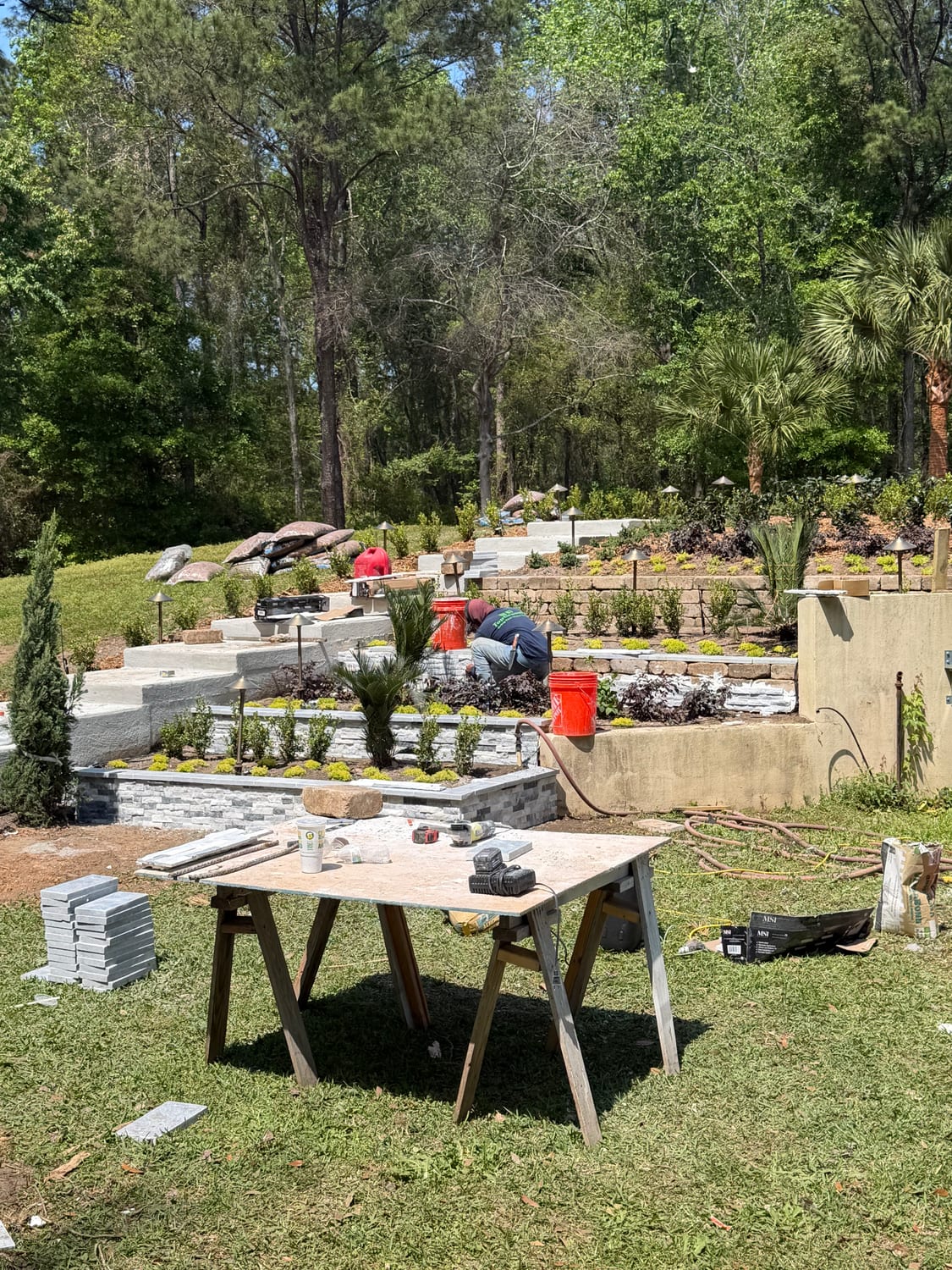 Multi-tier stone retaining wall build in progress