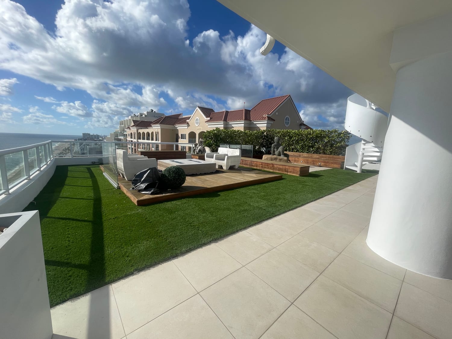 Rooftop artificial turf terrace with lounge seating and skyline views