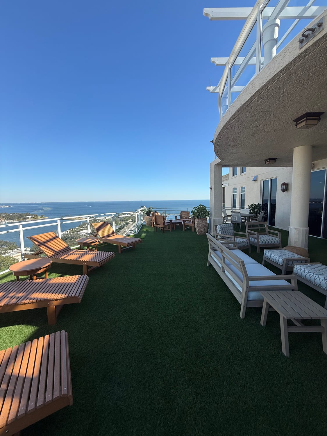 Oceanfront rooftop terrace with artificial turf and loungers