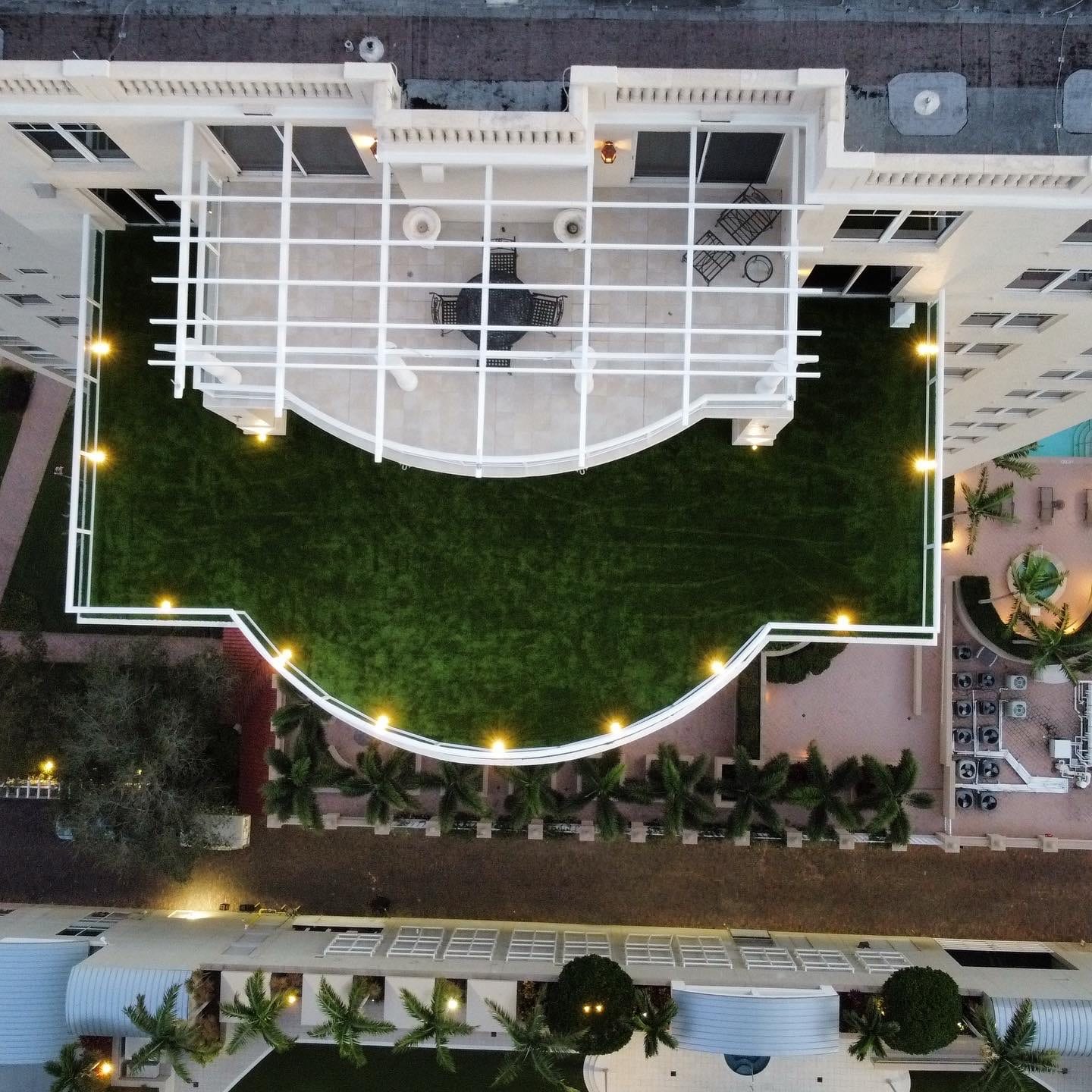 Aerial view of a rooftop artificial turf installation on a high-rise