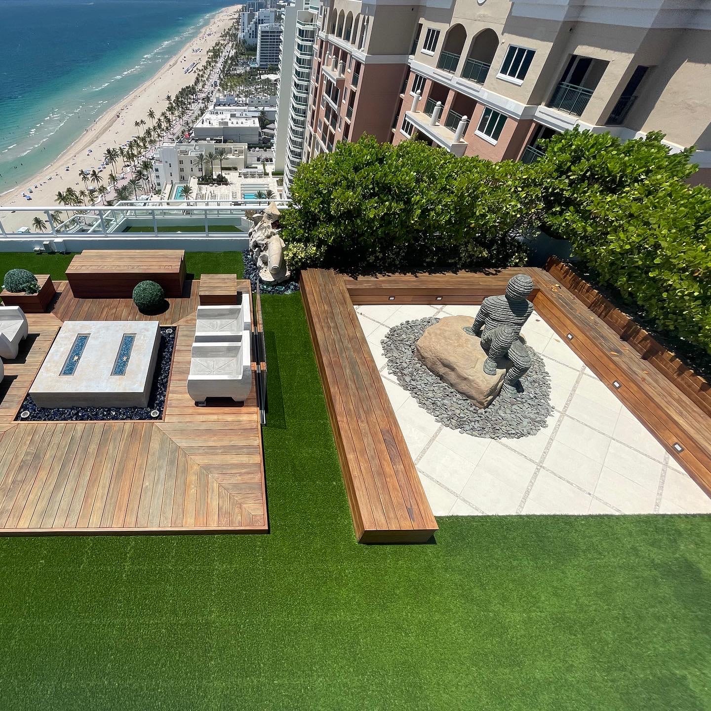 Rooftop turf deck with fire pit overlooking the beach