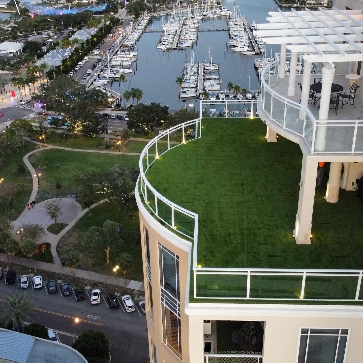 Rooftop artificial turf terrace above a marina